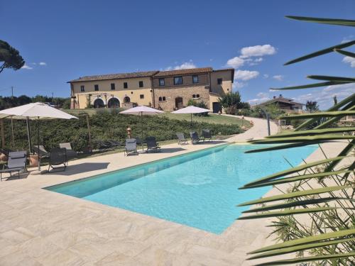 a swimming pool in front of a building at Casale Delle Stelle in Castello delle Forme