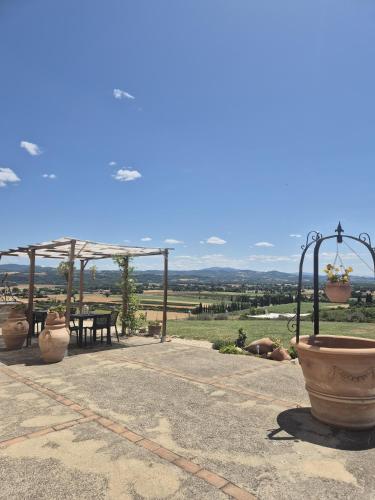 a patio with a table and chairs and a view at Casale Delle Stelle in Castello delle Forme