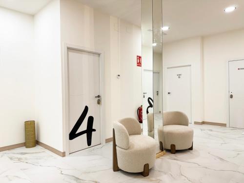 a lobby with two chairs and a number four at Boutique Palacio Centro in Alicante