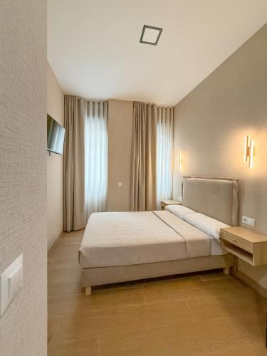 a bedroom with a large bed and a window at Boutique Palacio Centro in Alicante