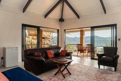 a living room with a couch and a table at Wolfkop Nature Reserve in Citrusdal