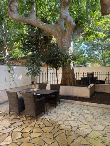 a table and chairs sitting next to a tree at chateau Laprade Narbonne in Narbonne