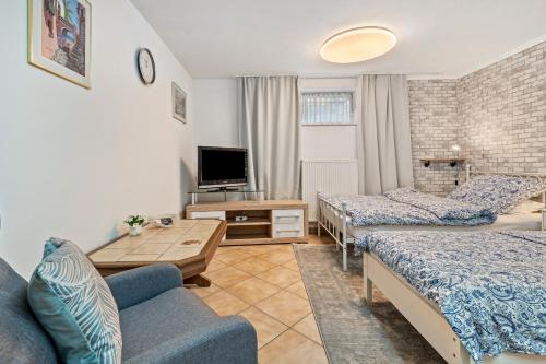 a living room with two beds and a couch at Gemütliche Ferienwohnung in Nittenau