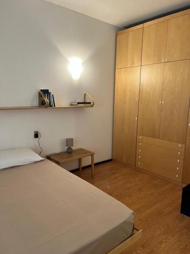 a bedroom with a bed and a wooden cabinet at Villetta Gloria in Venice-Lido