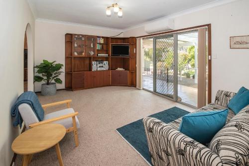 a living room with a couch and a table at Busselton Jetty Heritage House in Busselton