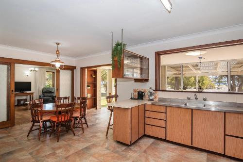 a kitchen and dining room with a table and chairs at Busselton Jetty Heritage House in Busselton