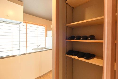 a kitchen with white cabinets and a sink at Asagaya House in Tokyo