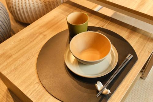 a cup of coffee on a plate on a table at Asagaya House in Tokyo