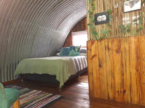 a bedroom with a bed in a round room at 11 Mountain Stream Hot Tub Self Catering in Gordonʼs Bay