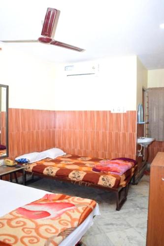 a room with two beds in a room at HOTEL SAVITRI Nearest Deoghar Mandir in Deoghar