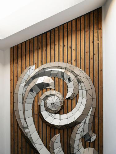 a letter s mural on a wood wall at Inspira Santos Boutique Hotel in Lisbon
