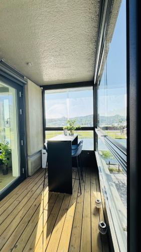 a dining room with a table and large windows at BJØRVIKA Apartment-Privat Lounge with Beautiful View & Close to everything in Oslo