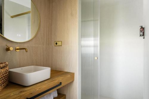 a bathroom with a white sink and a mirror at Hotel Mercury by ALEGRIA in Santa Susanna