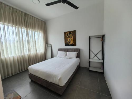 a bedroom with a bed and a ceiling fan at Simfoni Comfy Premium 03 in Langkawi Islands