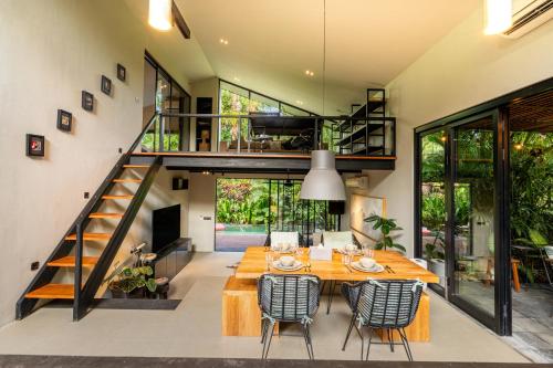 an open kitchen and dining room with a table and chairs at Loft 7 Villa by Betterplace in Canggu
