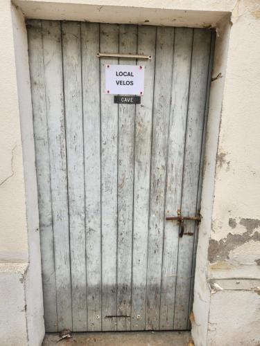 a metal door with a sign on top of it at Le cocon de Julia in Gray