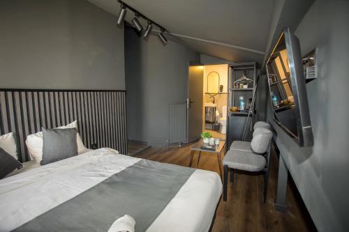 a bedroom with a large bed and a chair at Arkem City Hotel in Istanbul