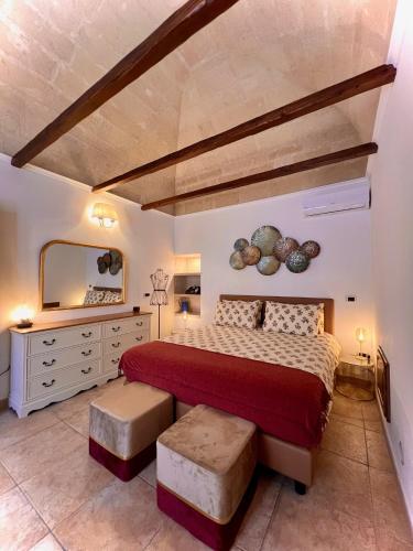 a bedroom with a red bed and a mirror at Le Dimore al Castello in Massafra