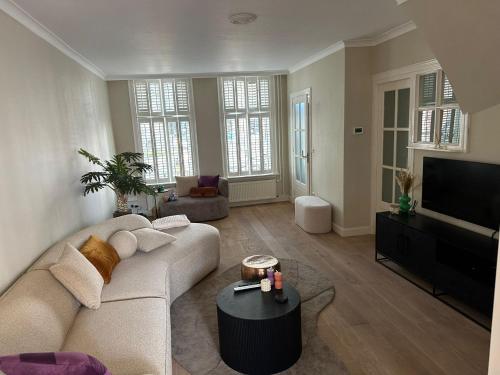 a living room with a couch and a flat screen tv at Beautiful entire house in the center in Medemblik