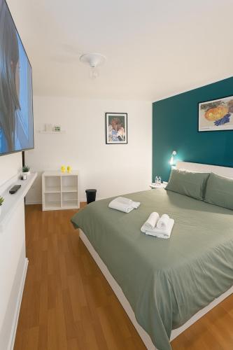 a bedroom with a large bed with two towels on it at Garibaldi Accommodation and Room in Viterbo