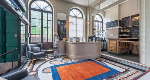 a lobby with a chair and a desk in a building at Best Western Urban Hotel in Lille