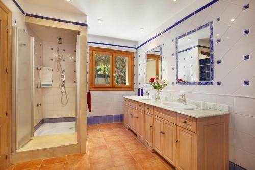a bathroom with a shower and a sink at Escape to Luxury: Rent Mallorca Villa 1452 in Cala Vinyes