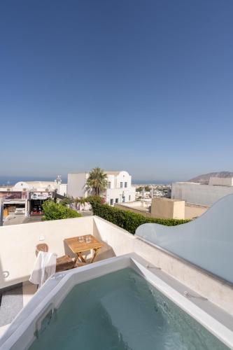 a swimming pool on the roof of a house at Winery Hotel 1870 in Fira