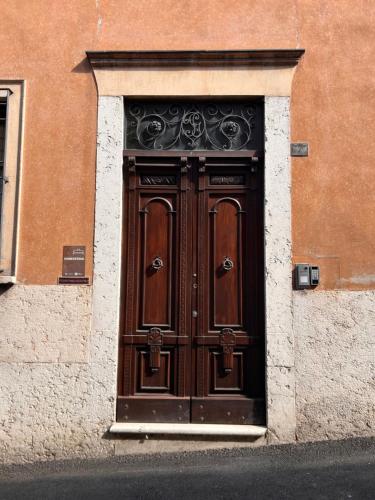 a large wooden door in the side of a building at Dimora 1848 - Foresteria Lombarda in Volta Mantovana
