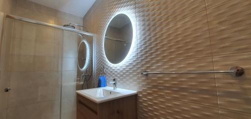 a bathroom with a sink and a mirror at Horizon Residence in Ix-Xagħra taʼ Barra