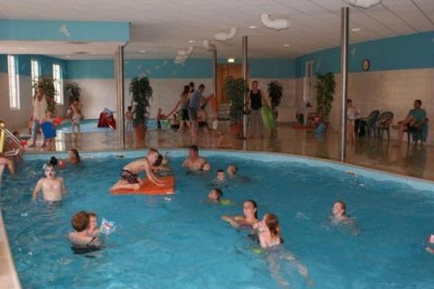 a group of people in a swimming pool at Vakantiehuis Diever in Diever