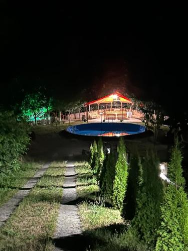 a boat in the water with a building in the background at Hovek Guest House in Dilijan