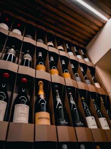 a bunch of bottles of wine on a shelf at Dimora Bonafede Ibla Design Rooms in Ragusa