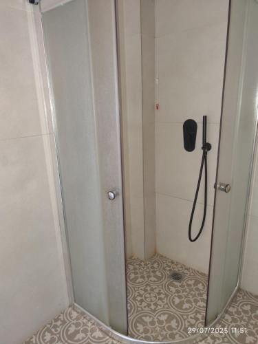 a shower with a glass door in a bathroom at 193 Urban Hotel in Patra
