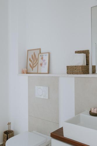 a bathroom with a sink and a white toilet at Villa Oleander by Domus Mirus - Rooftop Cinema & Pool & 6min Walk to Beach in Splitska