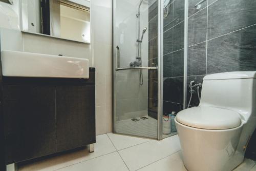a bathroom with a shower and a toilet and a sink at Danga Bay Seaview Escape 3BR 8pax Balcony by Our Stay in Johor Bahru