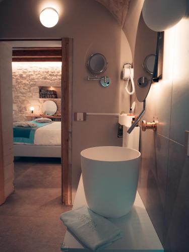 a bathroom with a large white tub in a room at Dimora Bonafede Ibla Design Rooms in Ragusa