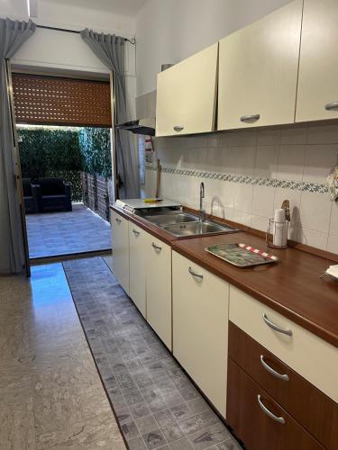 a kitchen with a sink and a counter top at Appartamento in villa in Torre a Mare