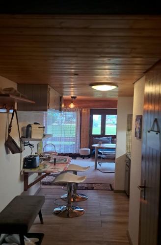 a kitchen and living room with a table and chairs at Très joli studio au centre de la station in Anzère
