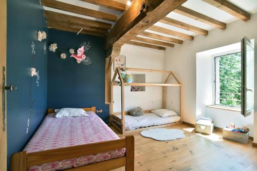 a bedroom with a bed and a bunk bed at La Bloutière - Avec grand jardin in La Bloutière
