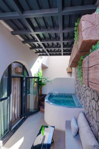 a hot tub on the patio of a house at The Cosmopolitan - Karterados Urban Suites in Karterados