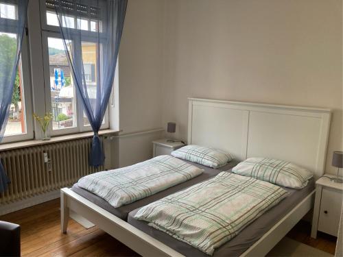 a bed with two pillows on it in a bedroom at Gästehaus Flair in Mettlach
