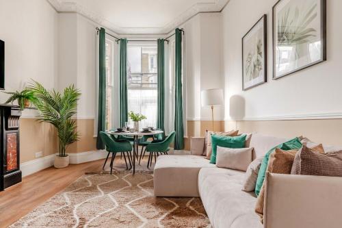 a living room with a couch and a table at West Kensigton Superb Apartments! in London
