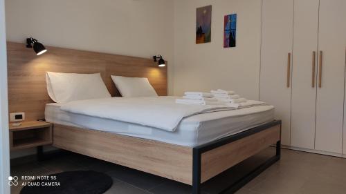 a bedroom with a large bed with white sheets at MAKS 2 Osijek Center, self check in in Osijek