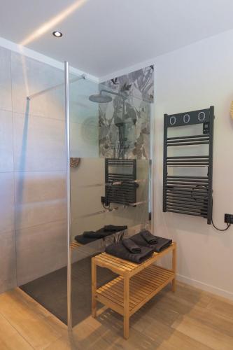 a shower stall with a bench in a room at L'écolodgia suite & spa in Saint-Étienne-lès-Remiremont