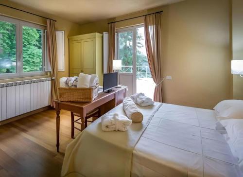 Postel nebo postele na pokoji v ubytování Hotel Terme Bagni Di Lucca