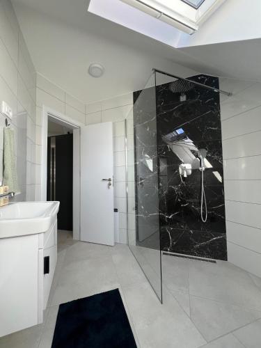 a bathroom with a shower and a sink at Natura Apartments in Kranj