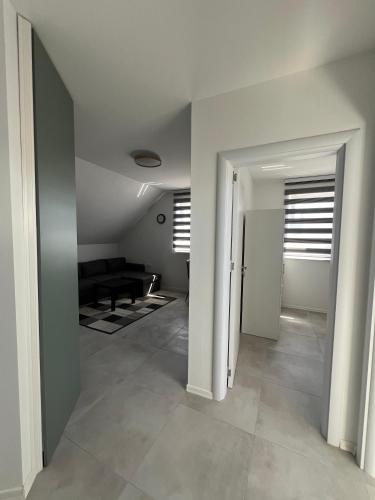 a hallway with a living room with a couch at Natura Apartments in Kranj