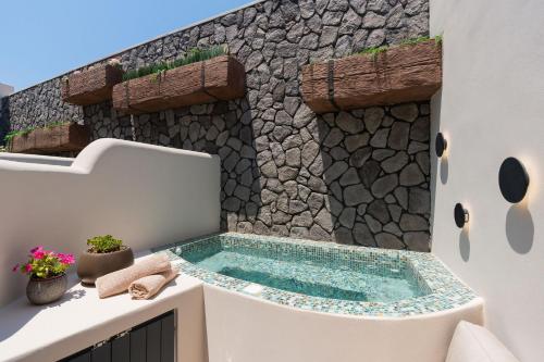 a hot tub in the corner of a house at The Cosmopolitan - Karterados Urban Suites in Karterados