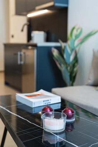 a table with a bowl and a box on it at The Cosmopolitan - Karterados Urban Suites in Karterados