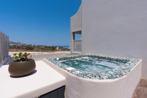 a hot tub on the balcony of a building at The Cosmopolitan - Karterados Urban Suites in Karterados
